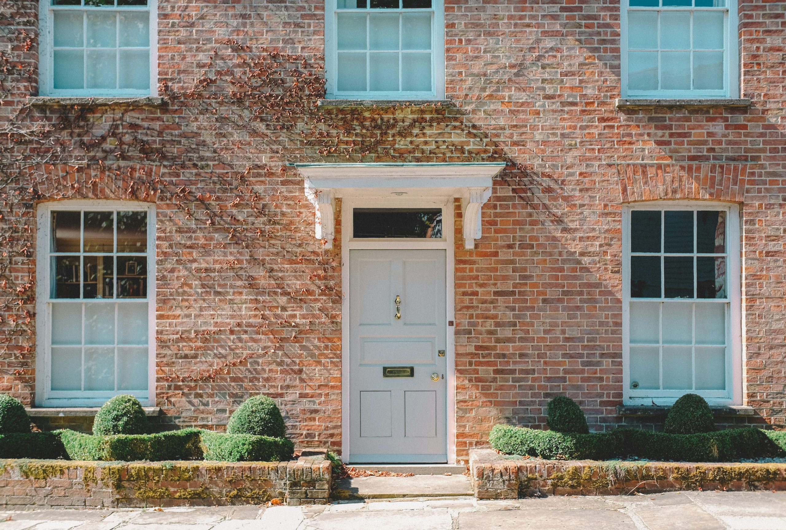 View of a house with 5 windows and a front door