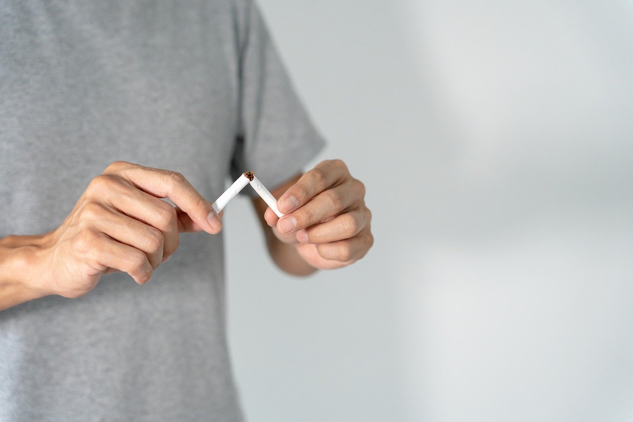 A person breaking a cigarette.