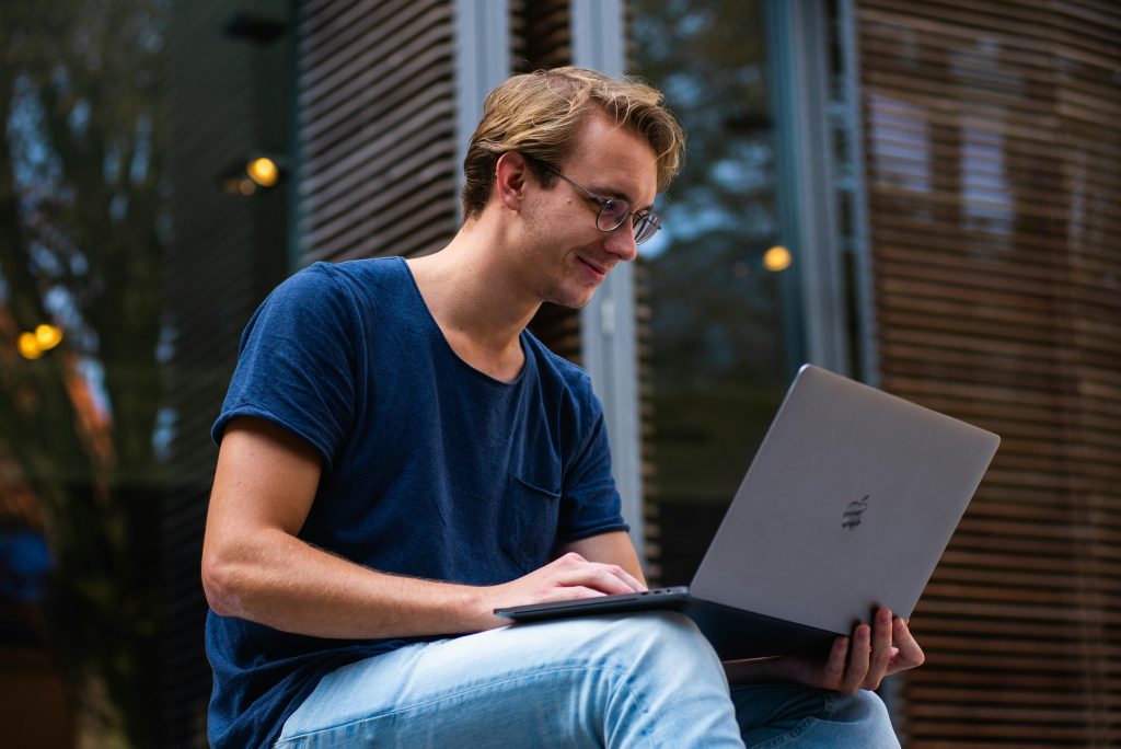 A man looking at his laptop.