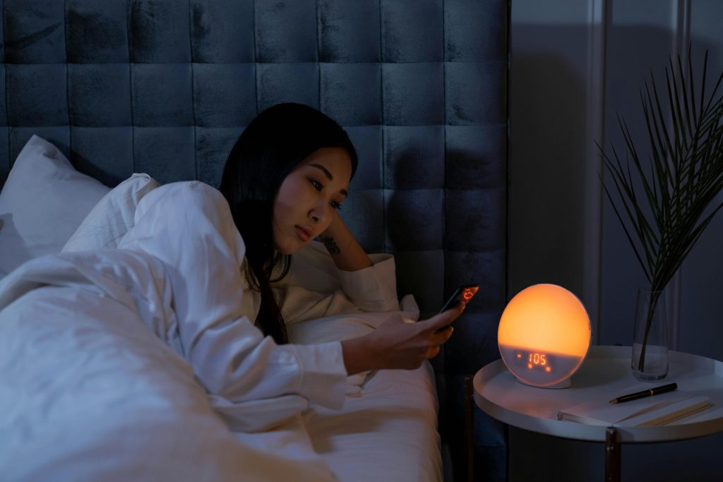 Person in bed with night light