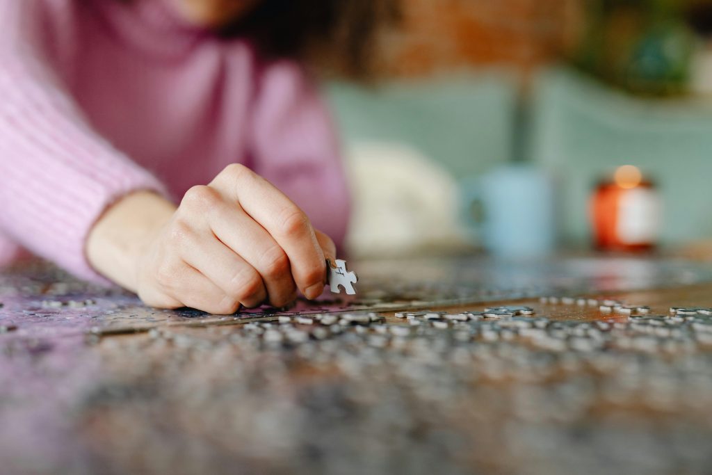 A person building jigsaw puzzles.