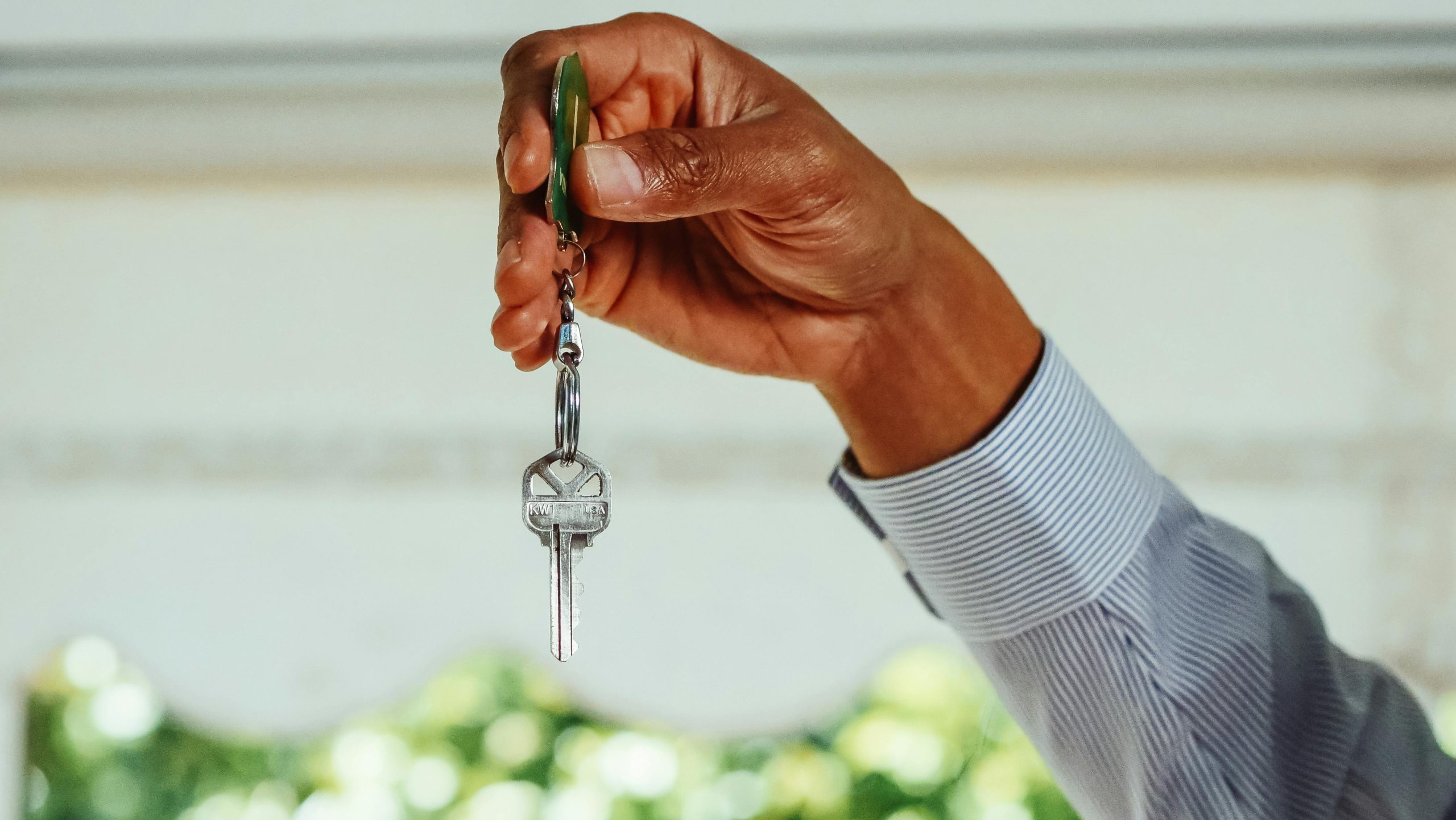 A person holding a house key.