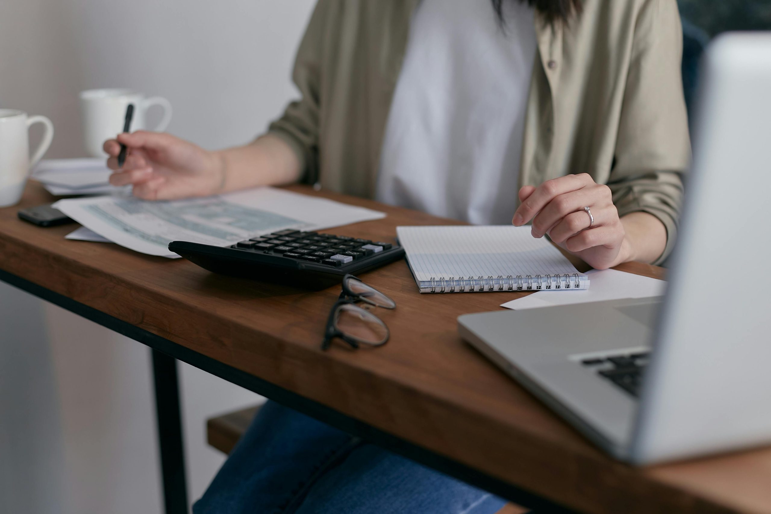 Person at computer with paperwork