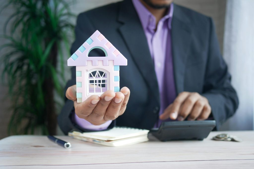 A person holding a little house.